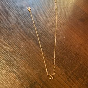 this is a very cute neckless with a cute bow on it.   great for layering